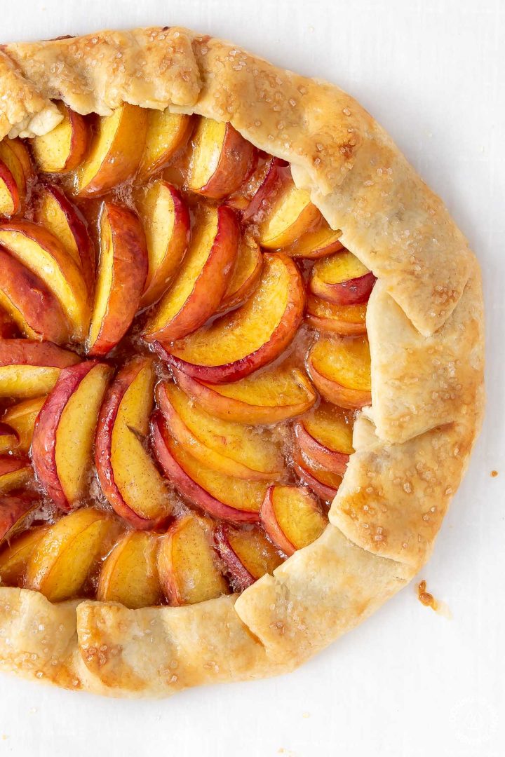 baked peach galette on a board