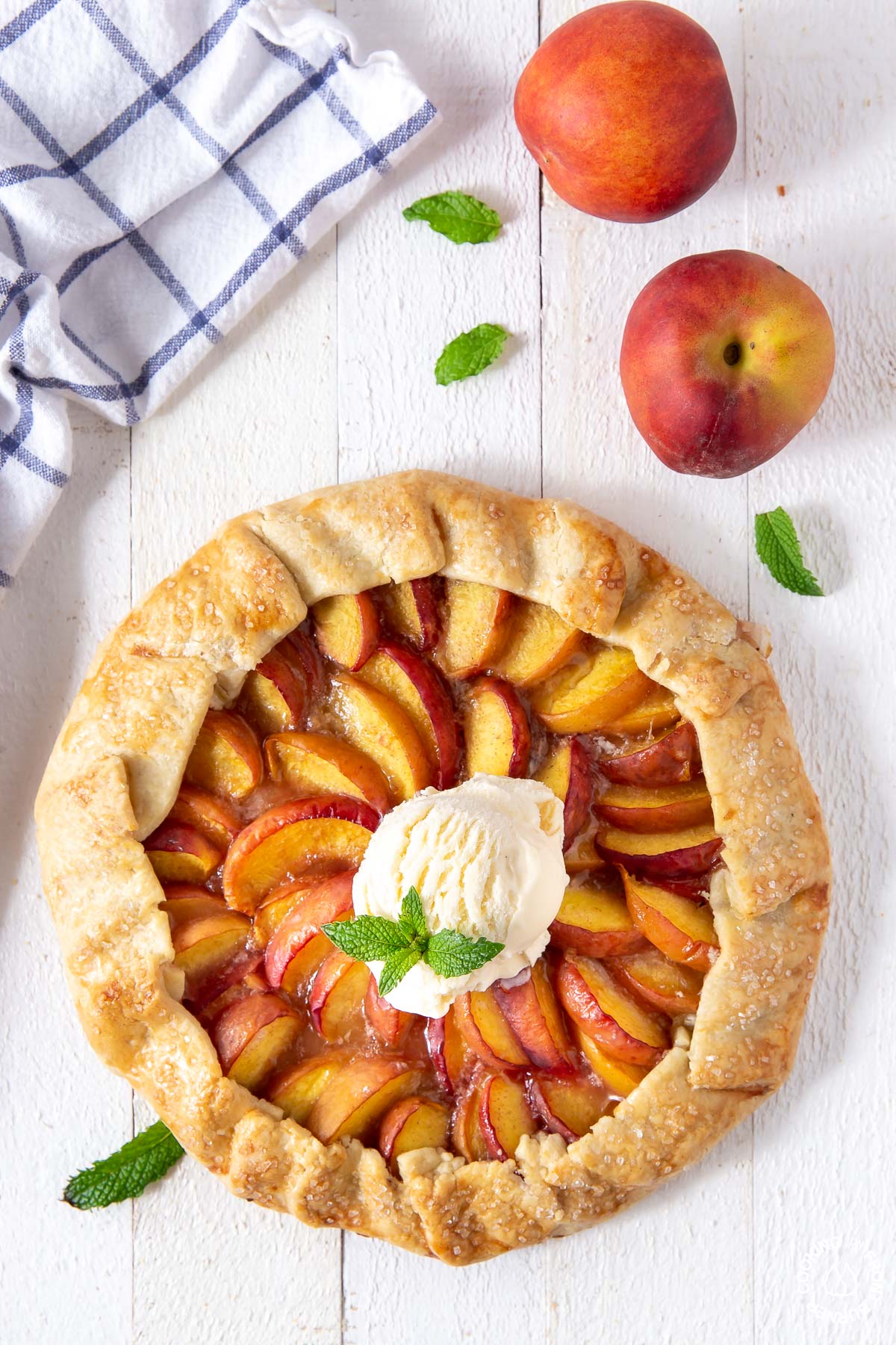 baked peach galette with vanilla ice cream on top