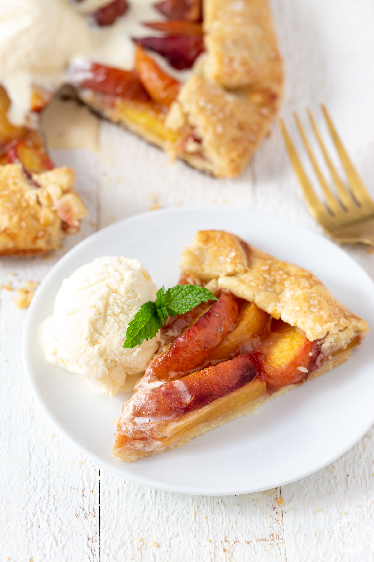 slice of peach galette with ice cream