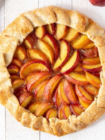 baked peach galette on a board