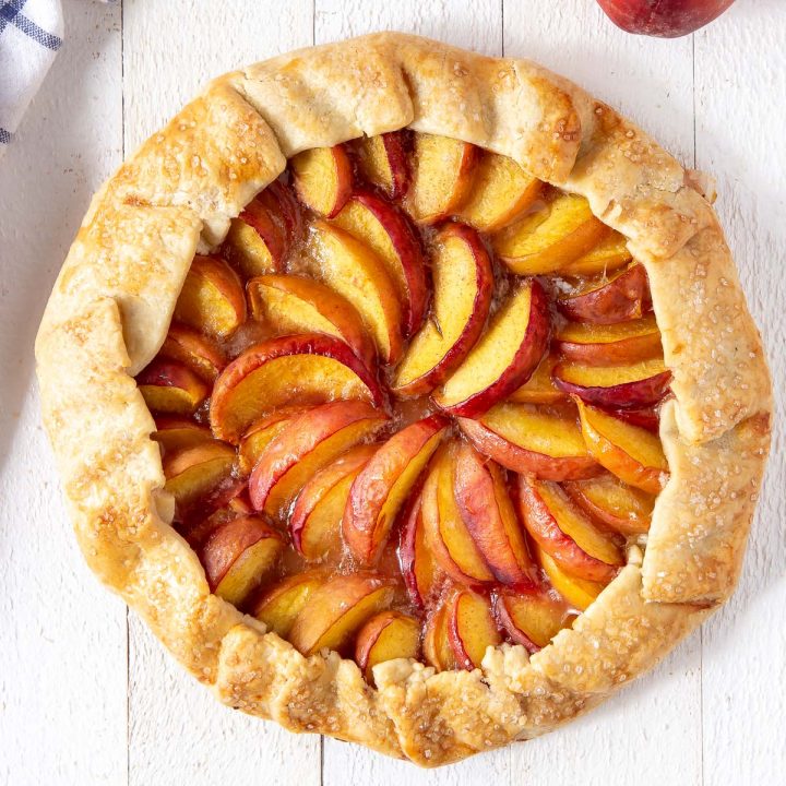 baked peach galette on a board