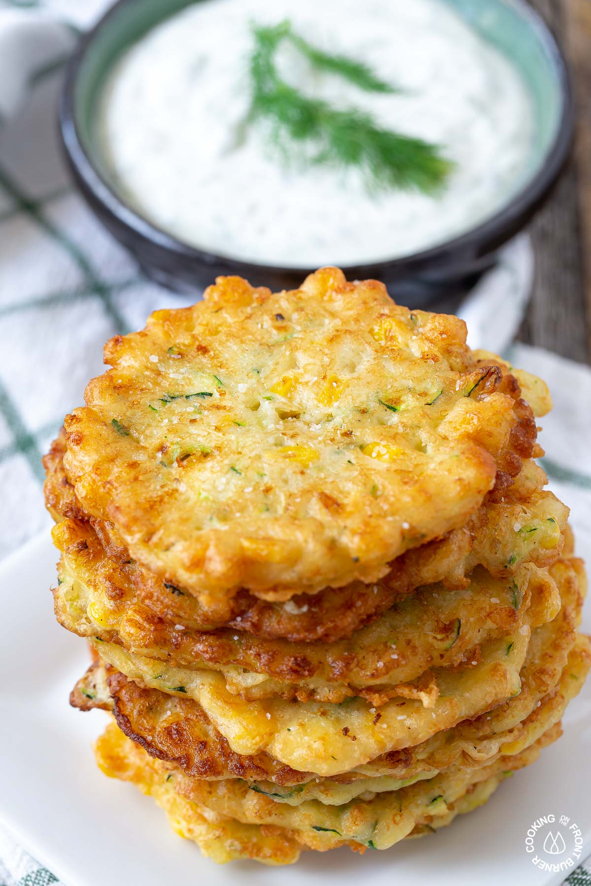 a stack of fried zucchini corn fritters on a plate