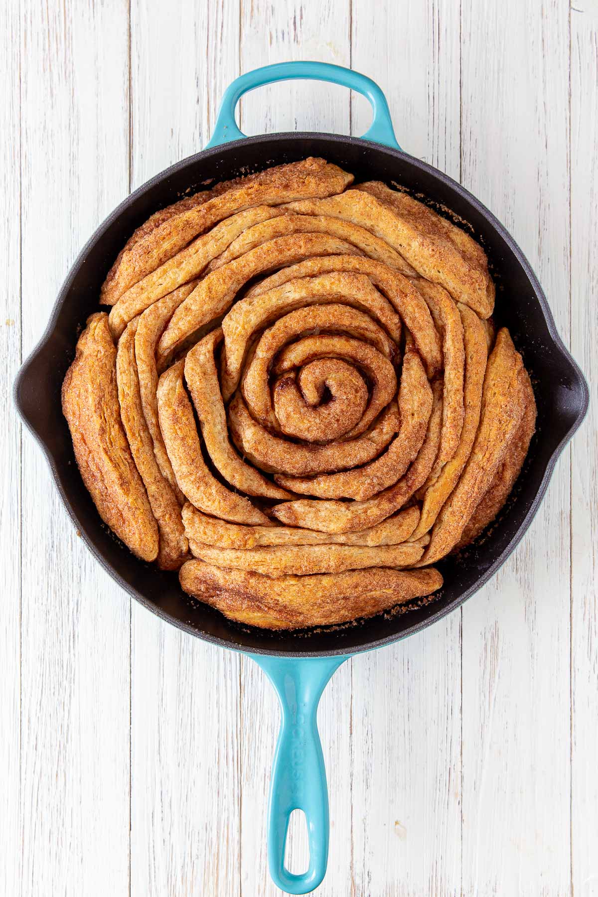 a baked giant cinnamon roll in a skillet