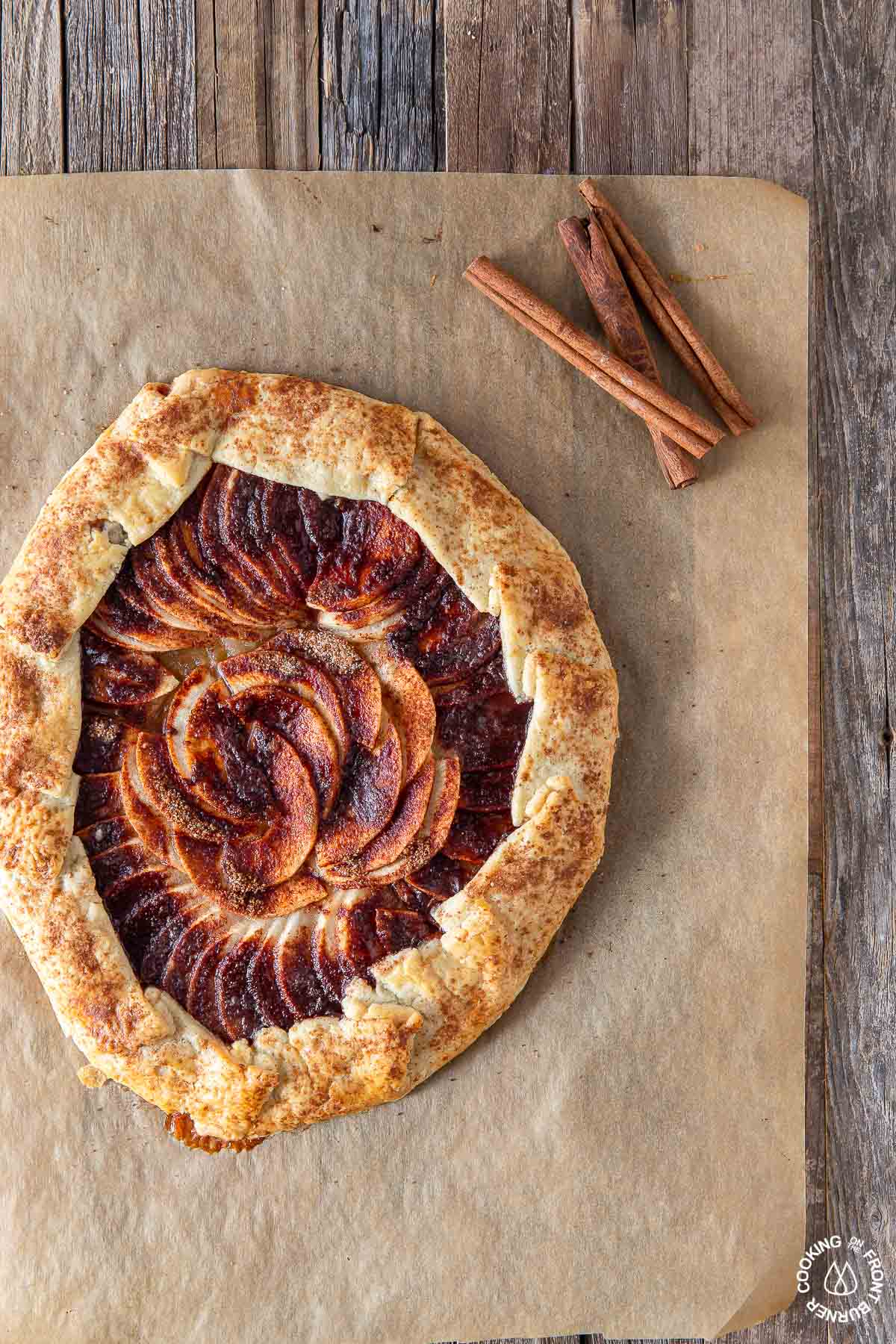 rustic apple galette on parchment paper on a board