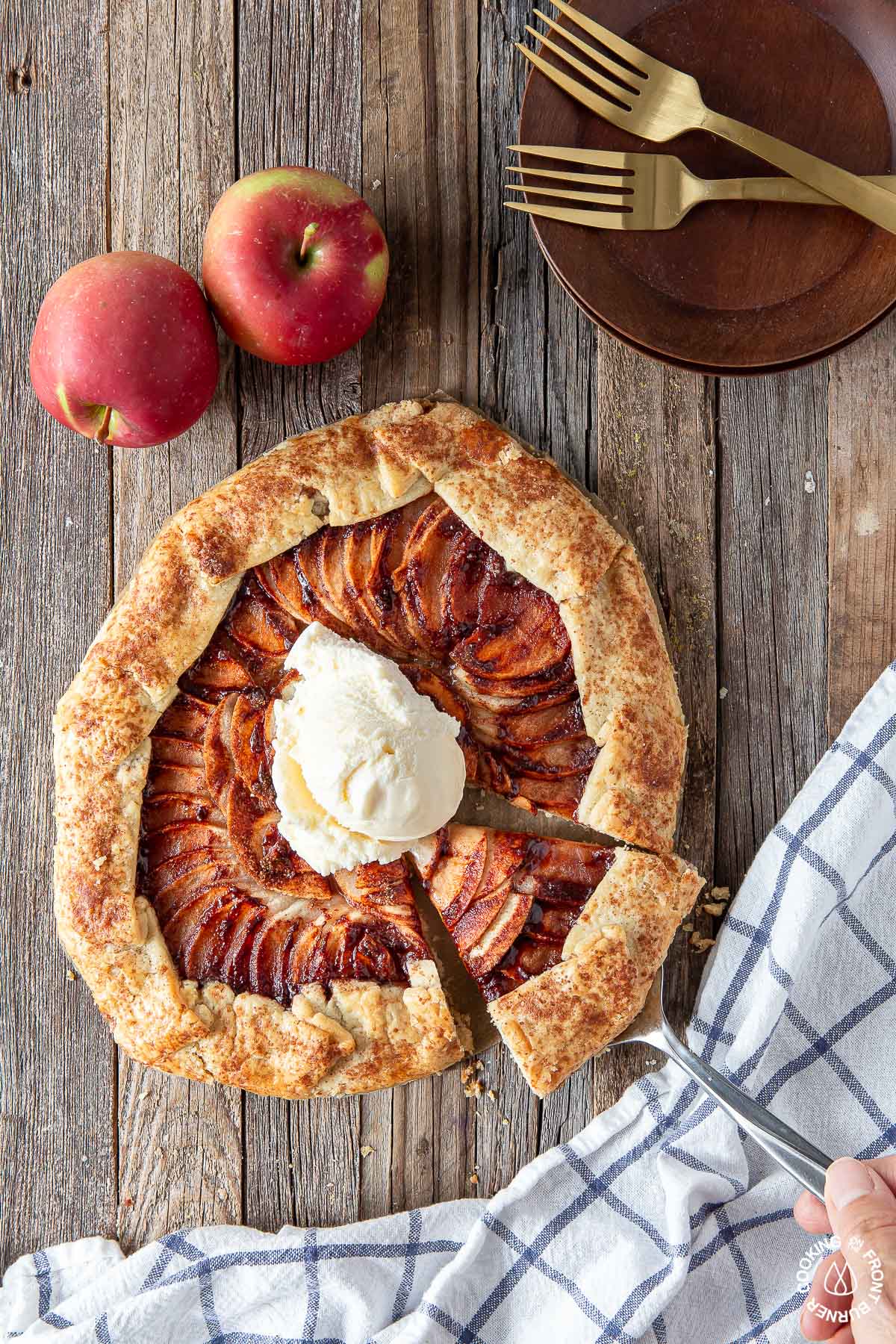 apple galette on a board topped with vanilla ice cream