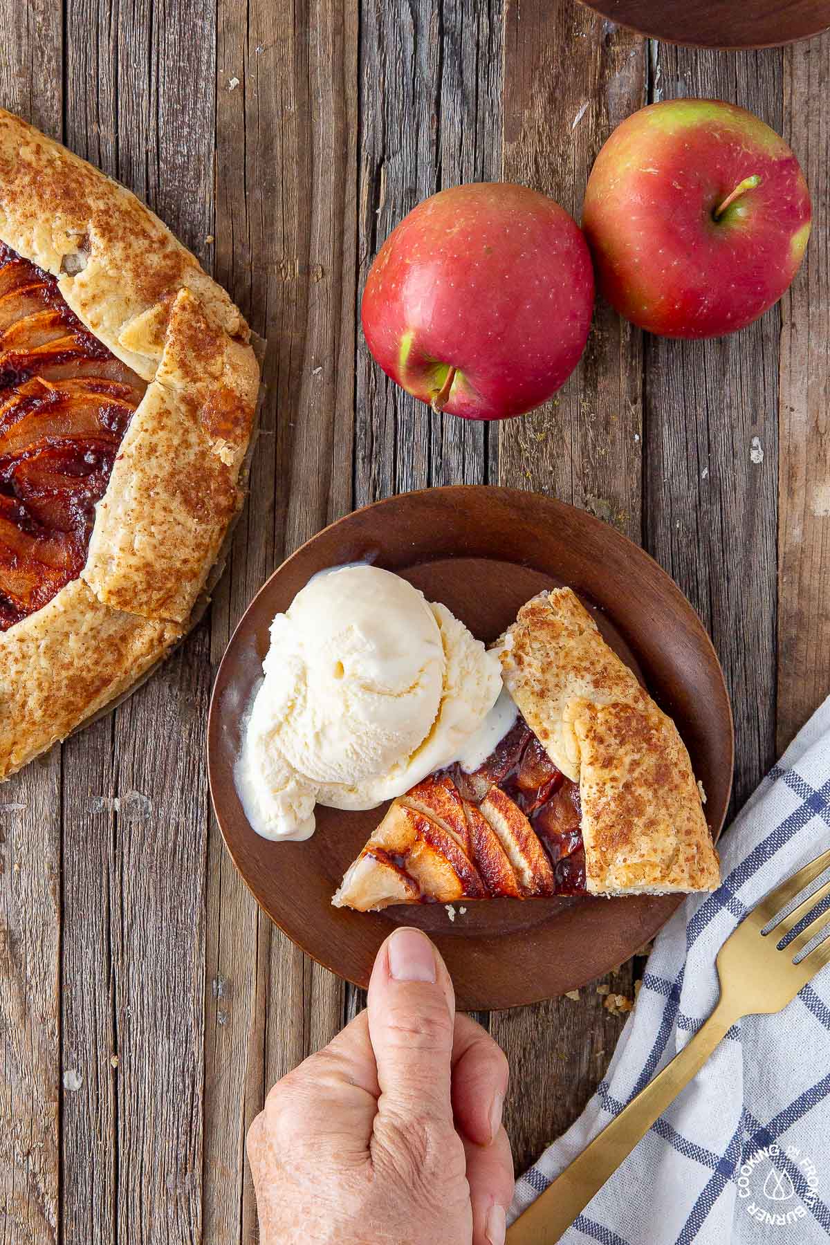 a slice of rustic apple galette on a plate with ice cream