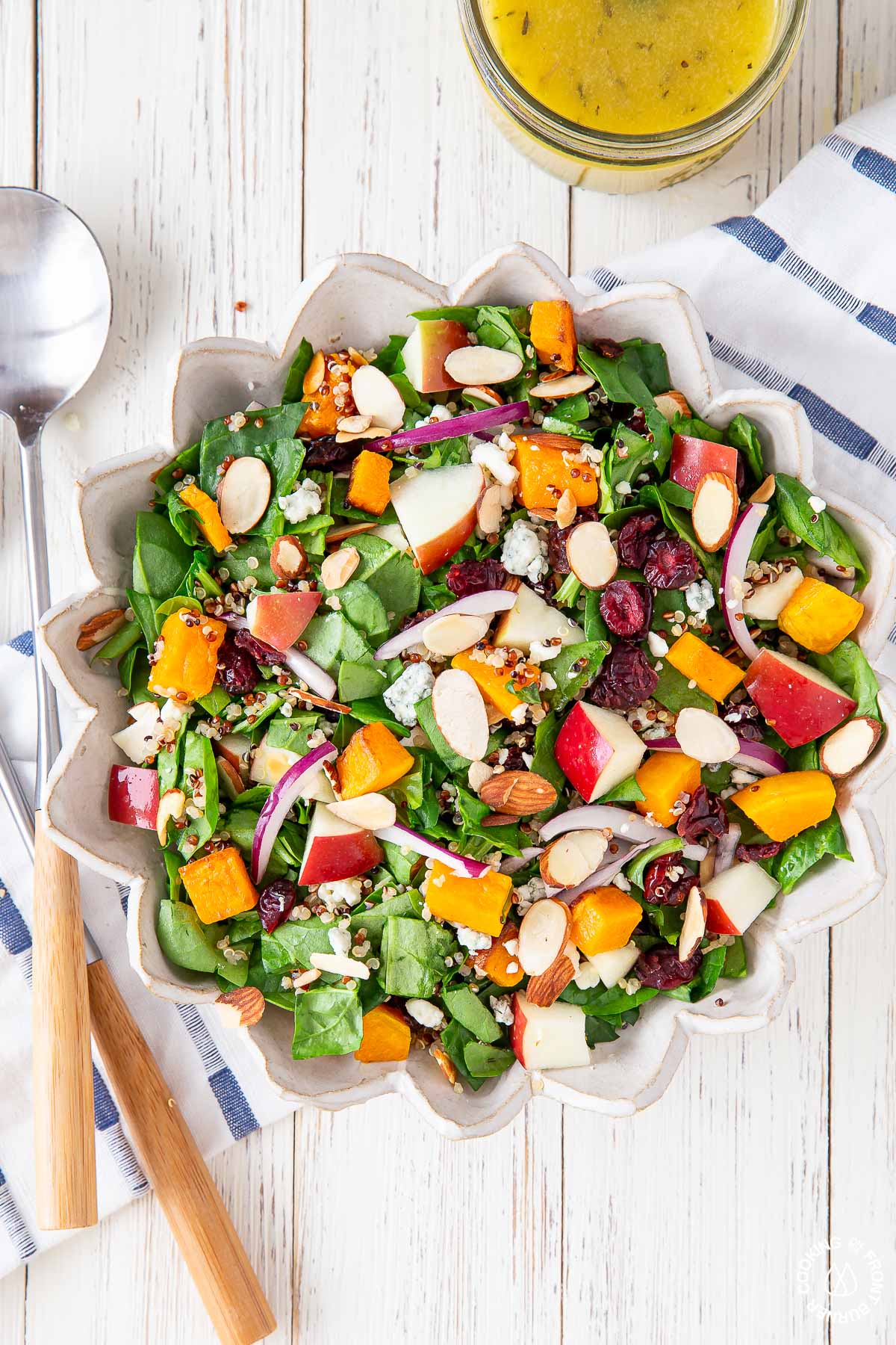 chopped spinach fall salad in a white bowl