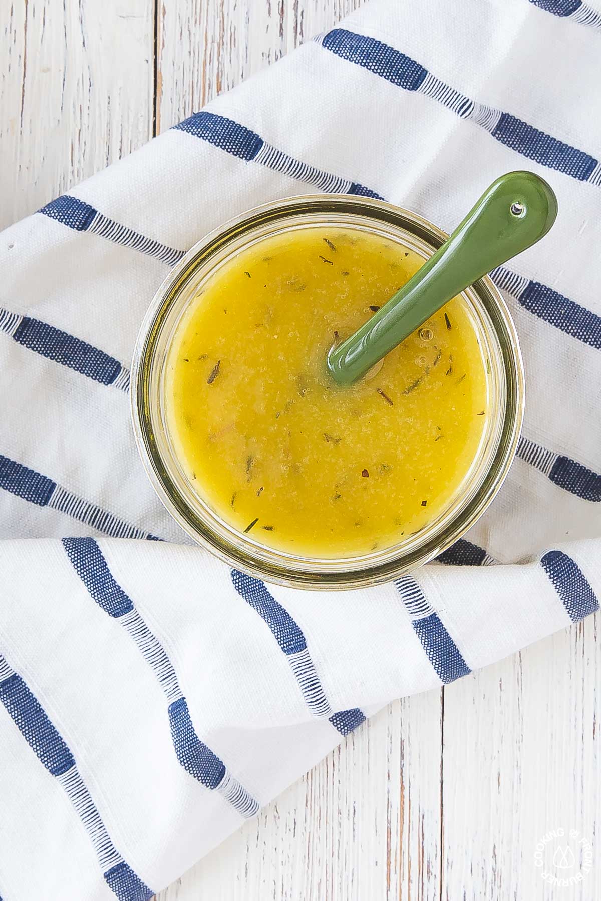 a small glass mason jar with maple vinaigrette in it