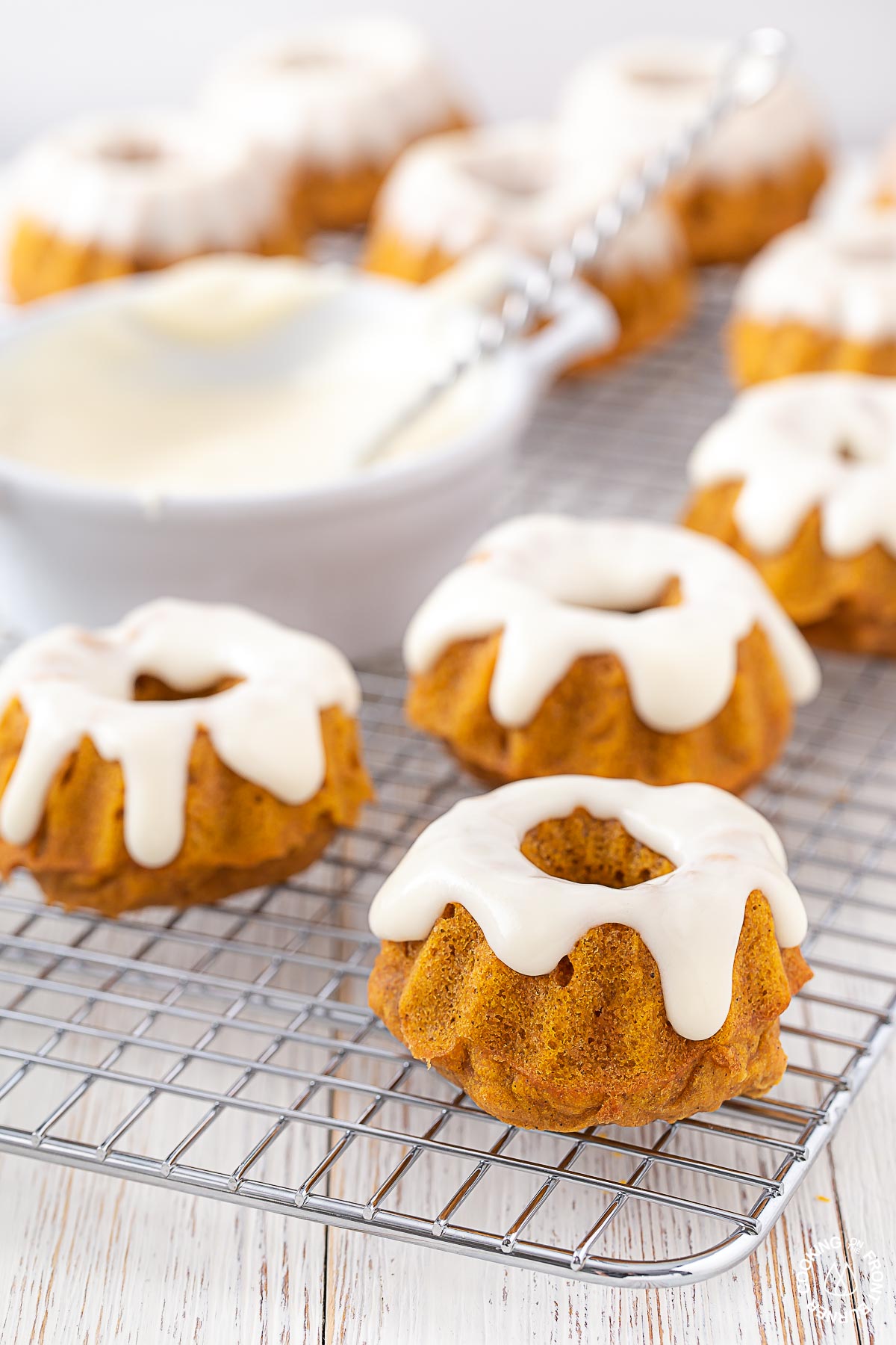 glazed mini pumpkin spice bundt cakes on a cooling rack