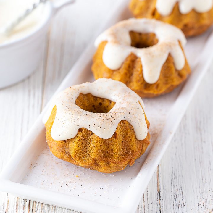 two mini pumpkin spice bundt cakes on a white plate