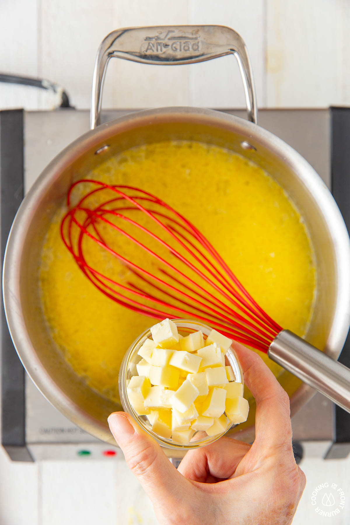 adding cubed butter to lemon sugar mixture in a saucepan