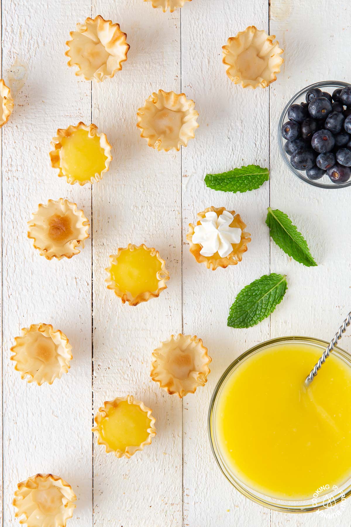 tarts on a board filled with lemon curd