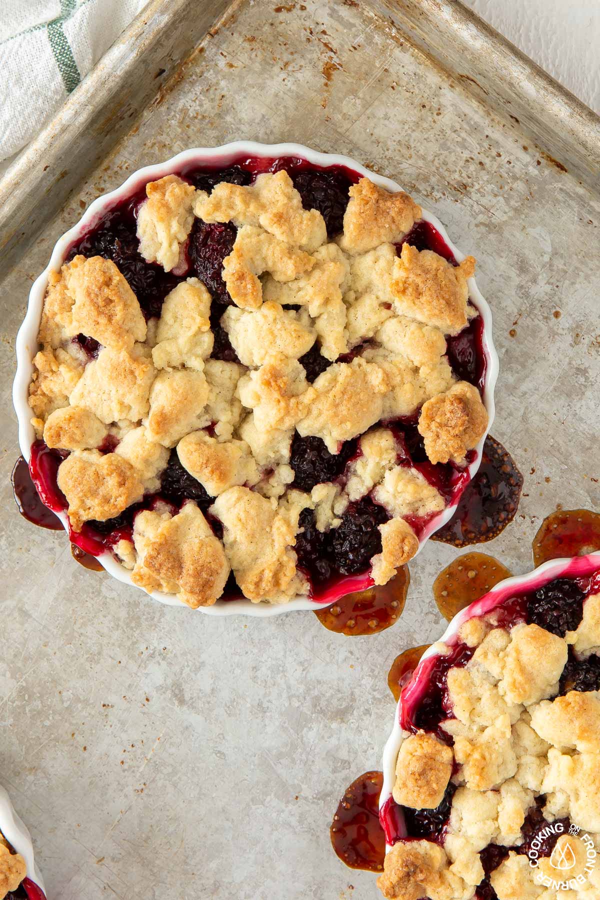 baked blackberry crumble tarts on a baking sheet