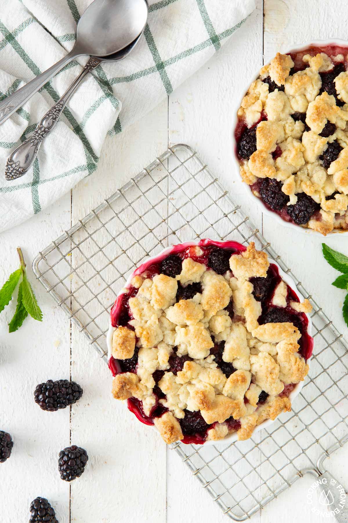 two blackberry crumbles on a white board