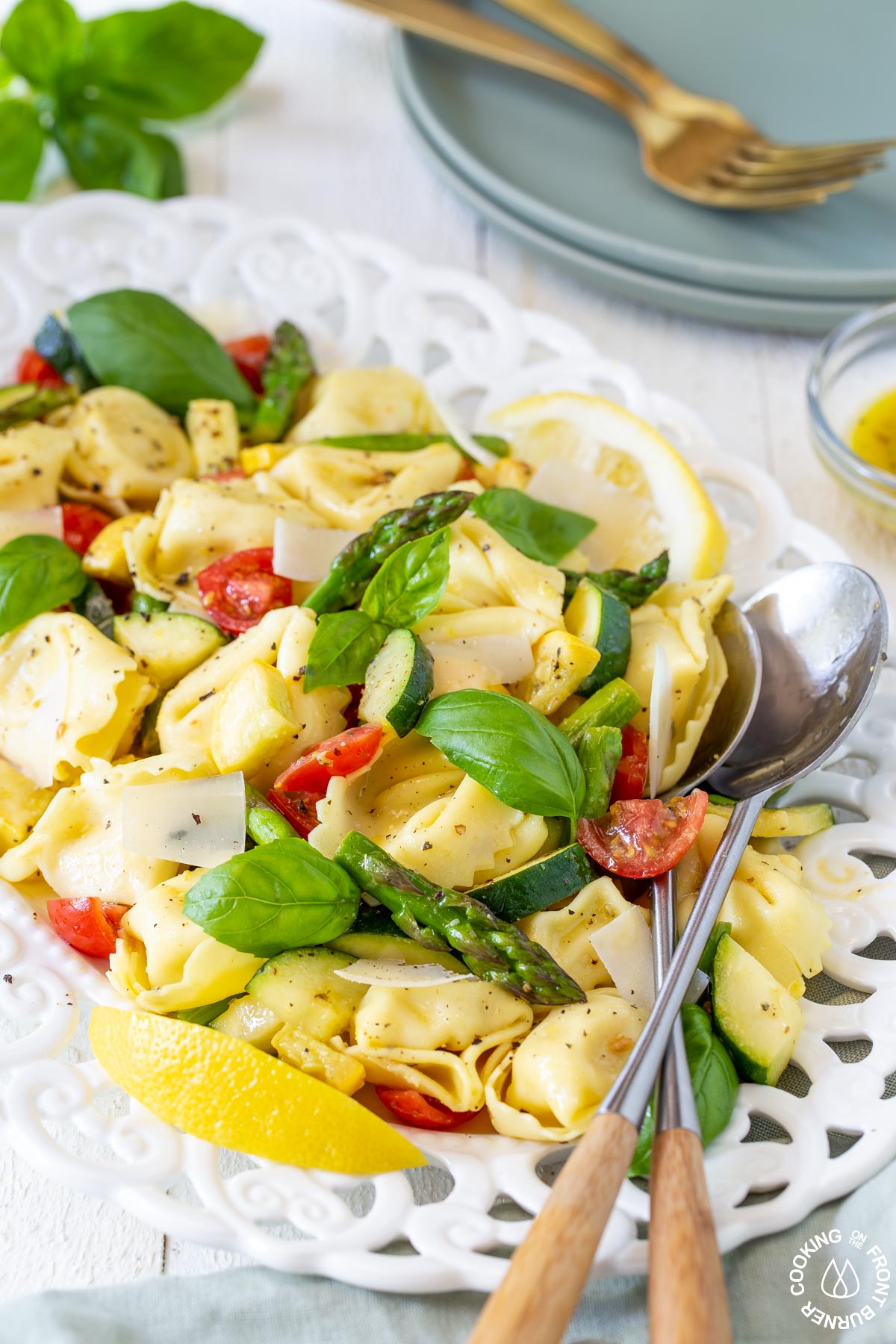 a white dish with tortellini salad in it