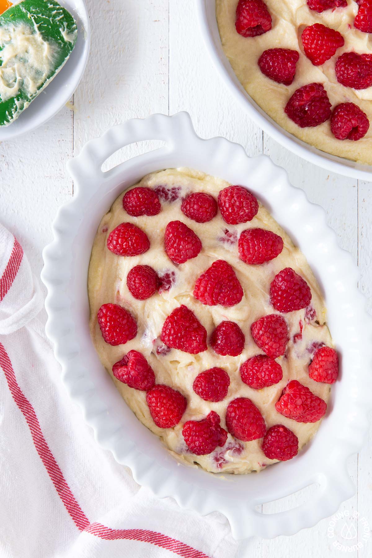 cake batter with adding raspberries on top