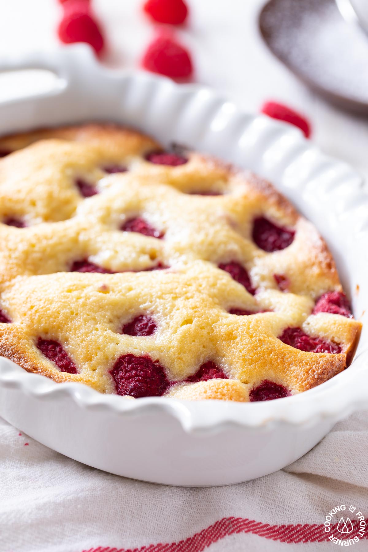 baked lemon raspberry buckle cake in a white baking dish