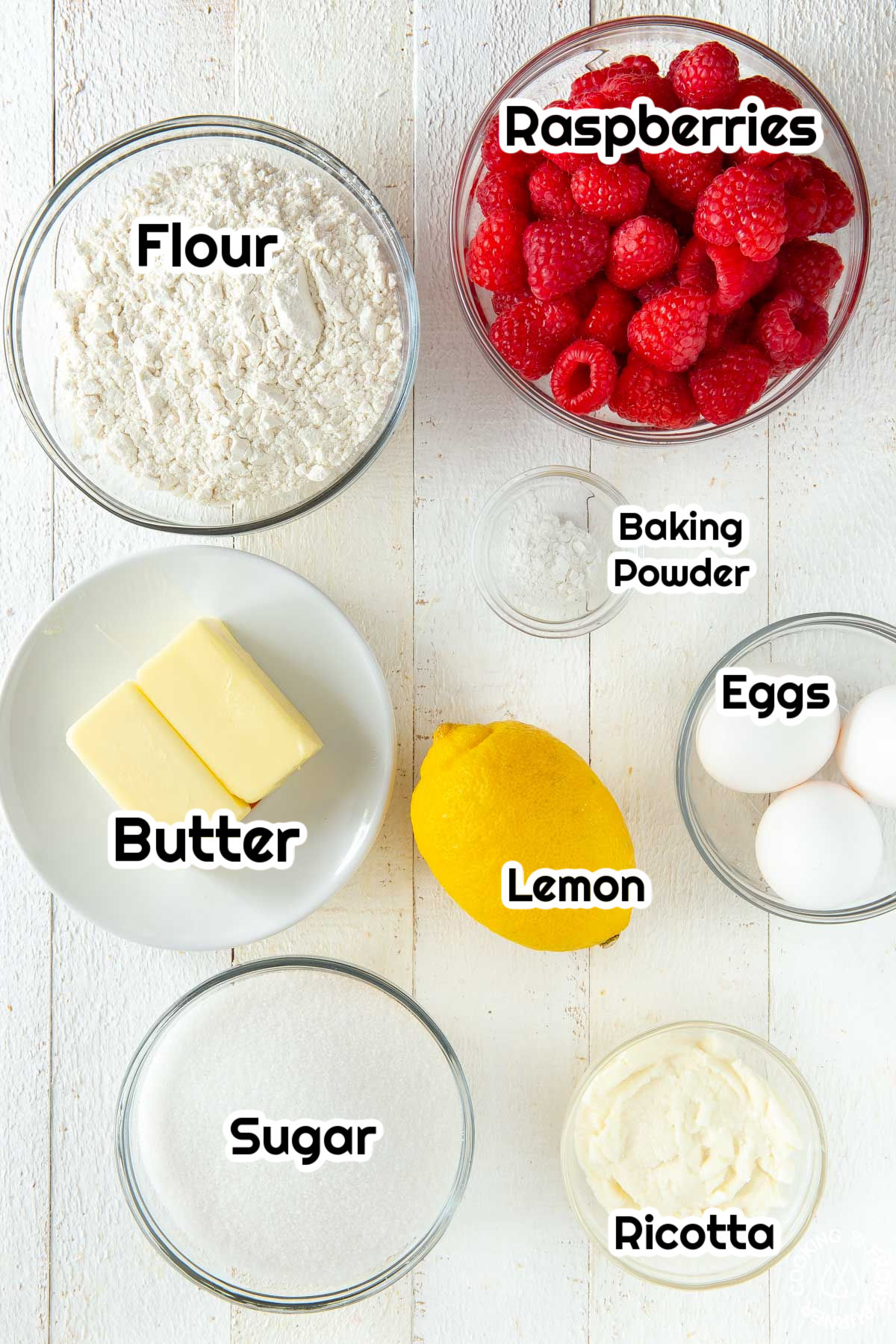 flour, sugar, butter, lemon, baking powder, raspberries, eggs in a bowl