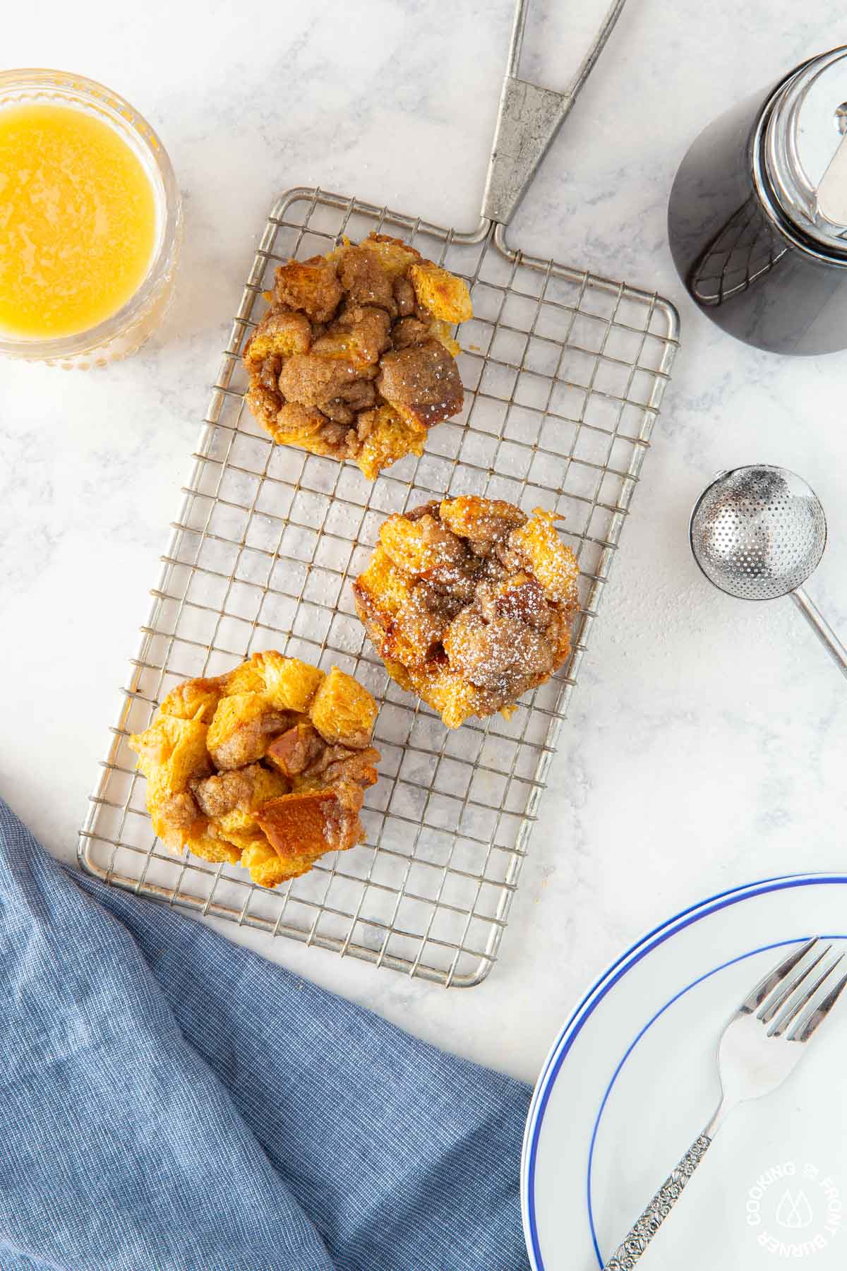 3 pumpkin butter french toast muffins on a cooling rack