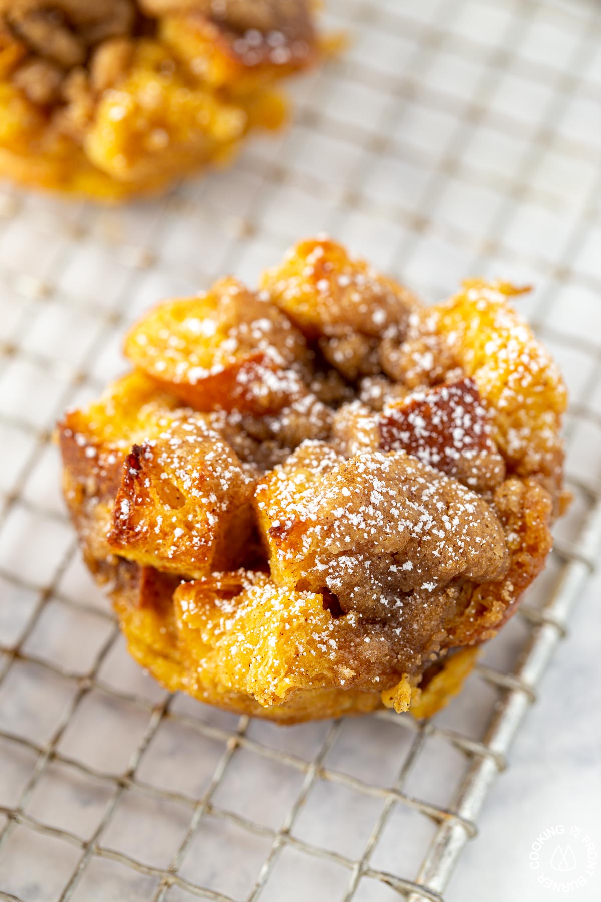 one pumkpin butter muffin on a cooling grate