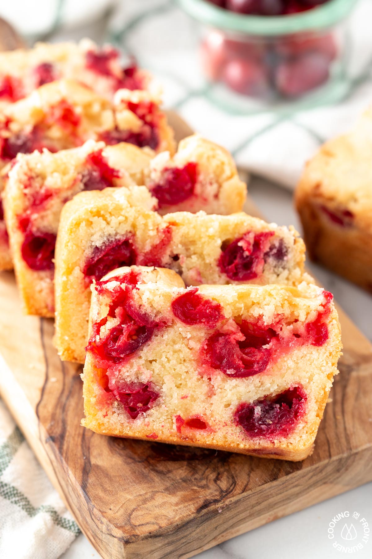 slicesof cranberry bread on a cutting board