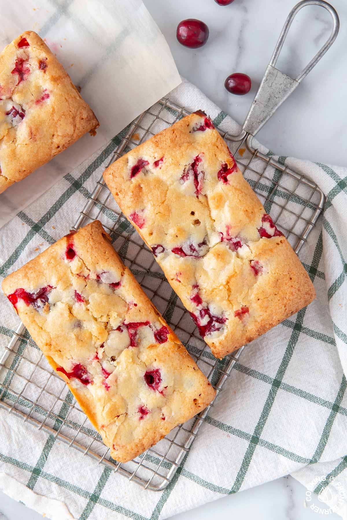 loaves of cranberry bread on a wire rack