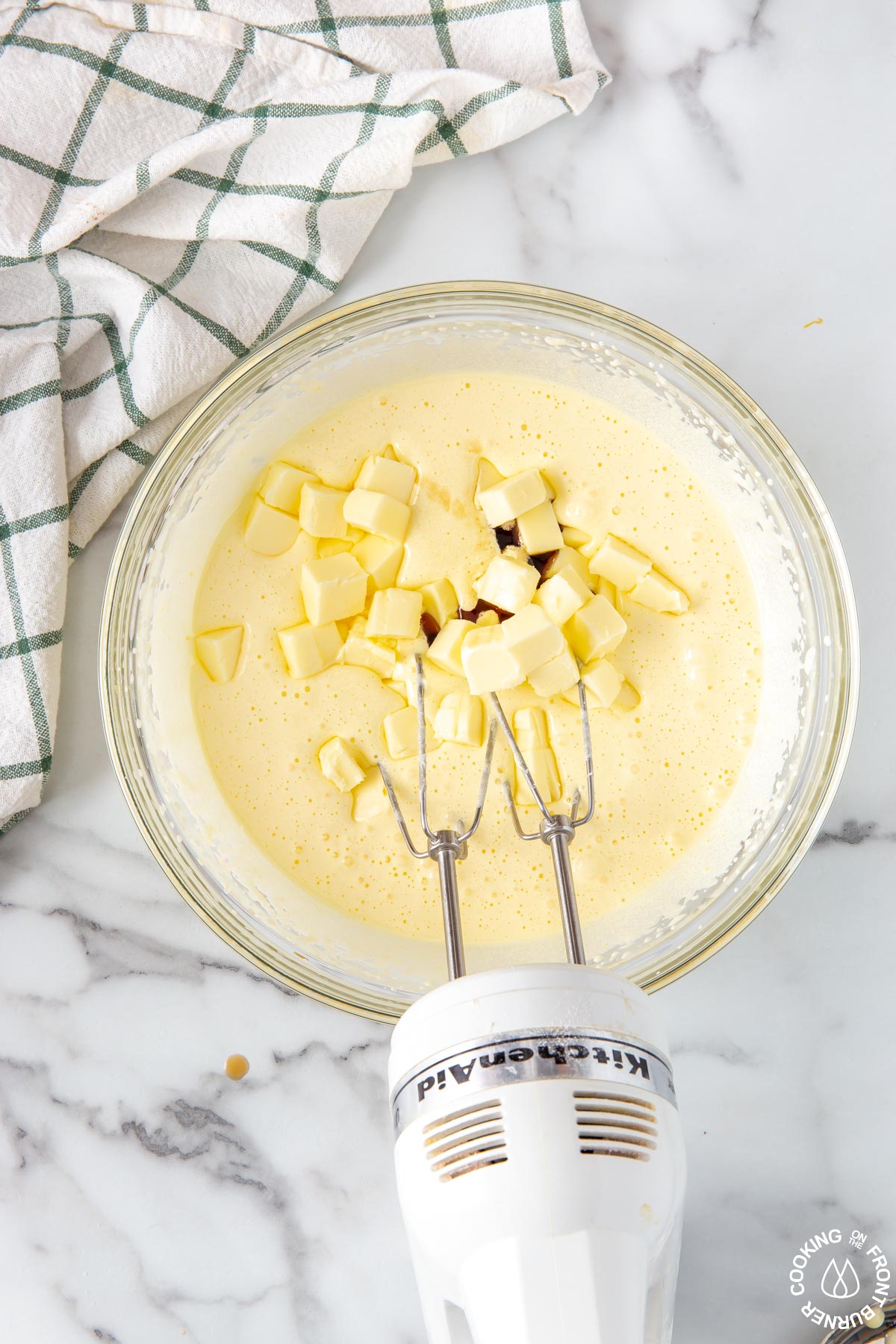 adding butter and vanilla to a sugar/egg mixture