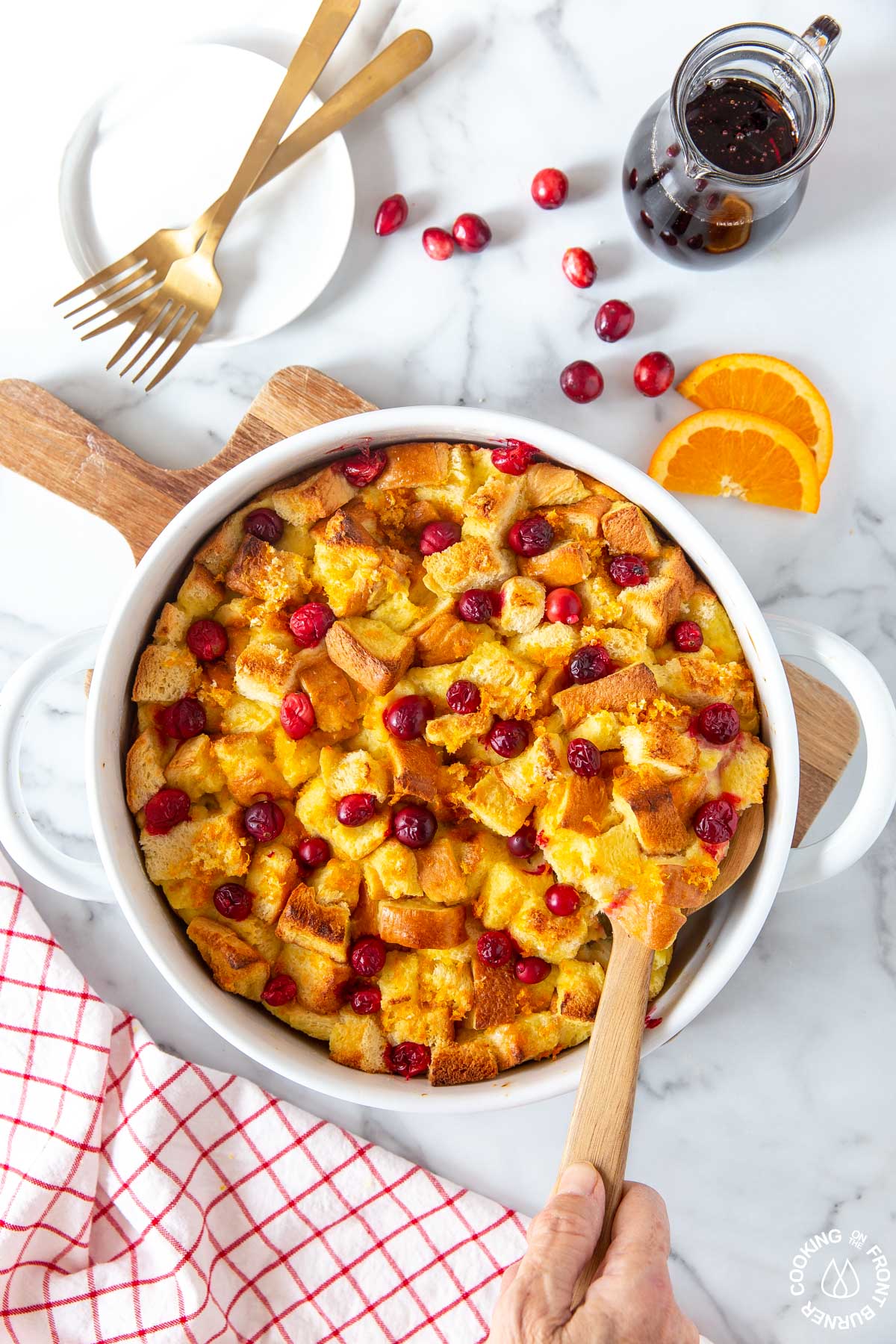 baked orange cranberry french toast bake in a white baking dish