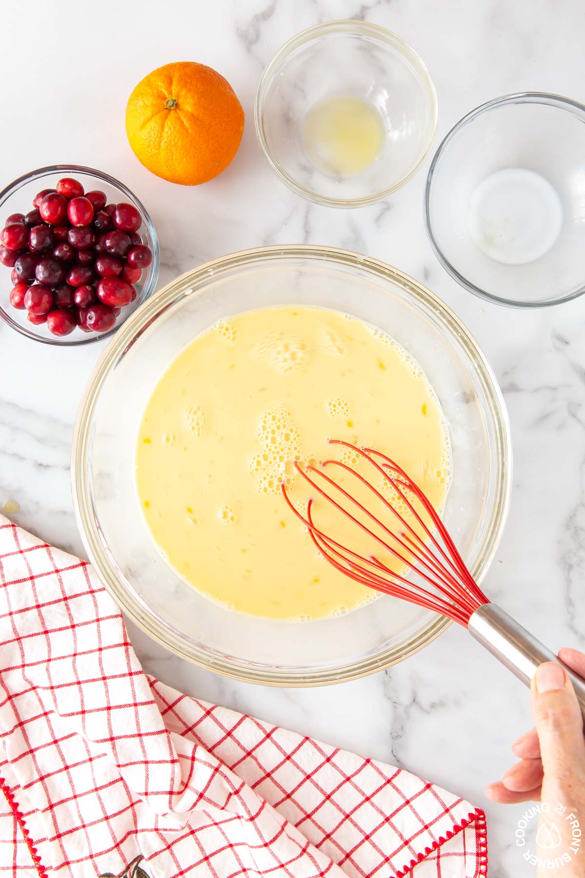 eggs, milk and OJ whisked in a bowl