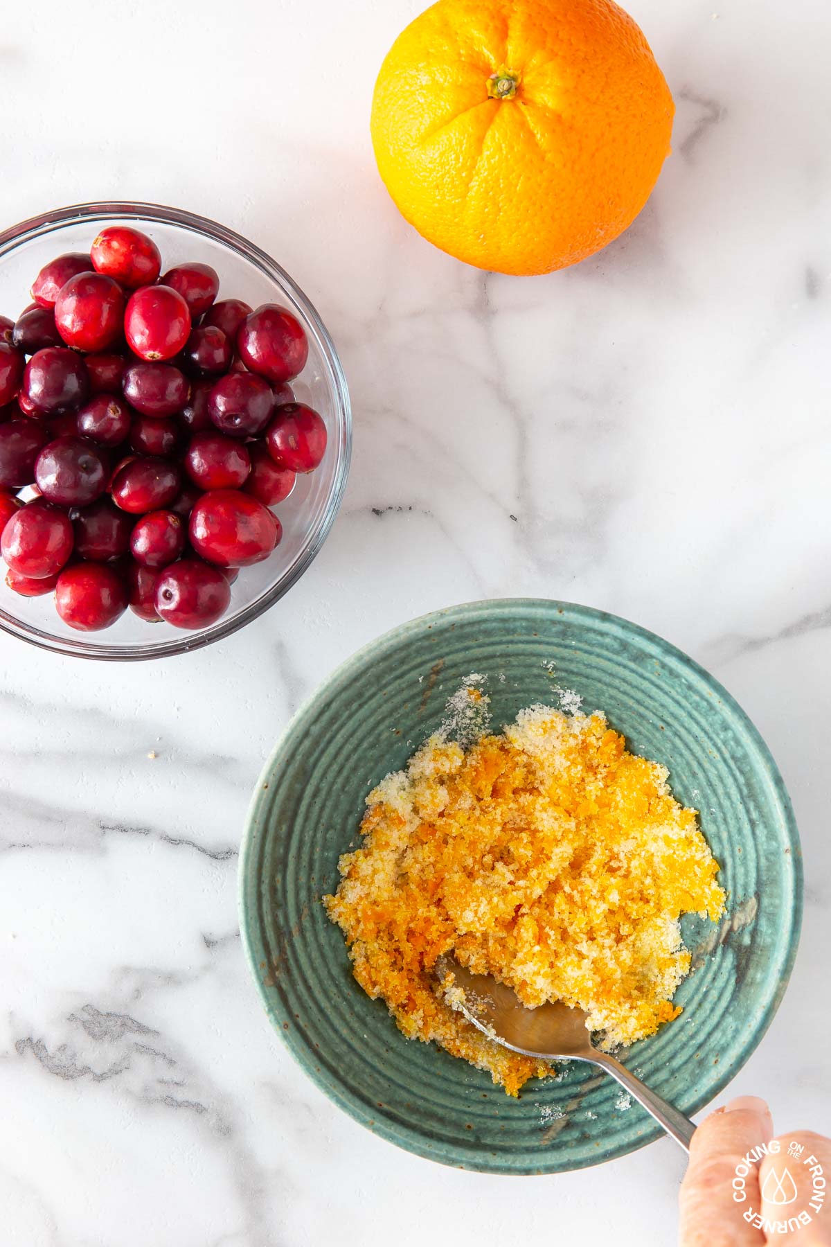 orange zest and sugar in a blue bowl