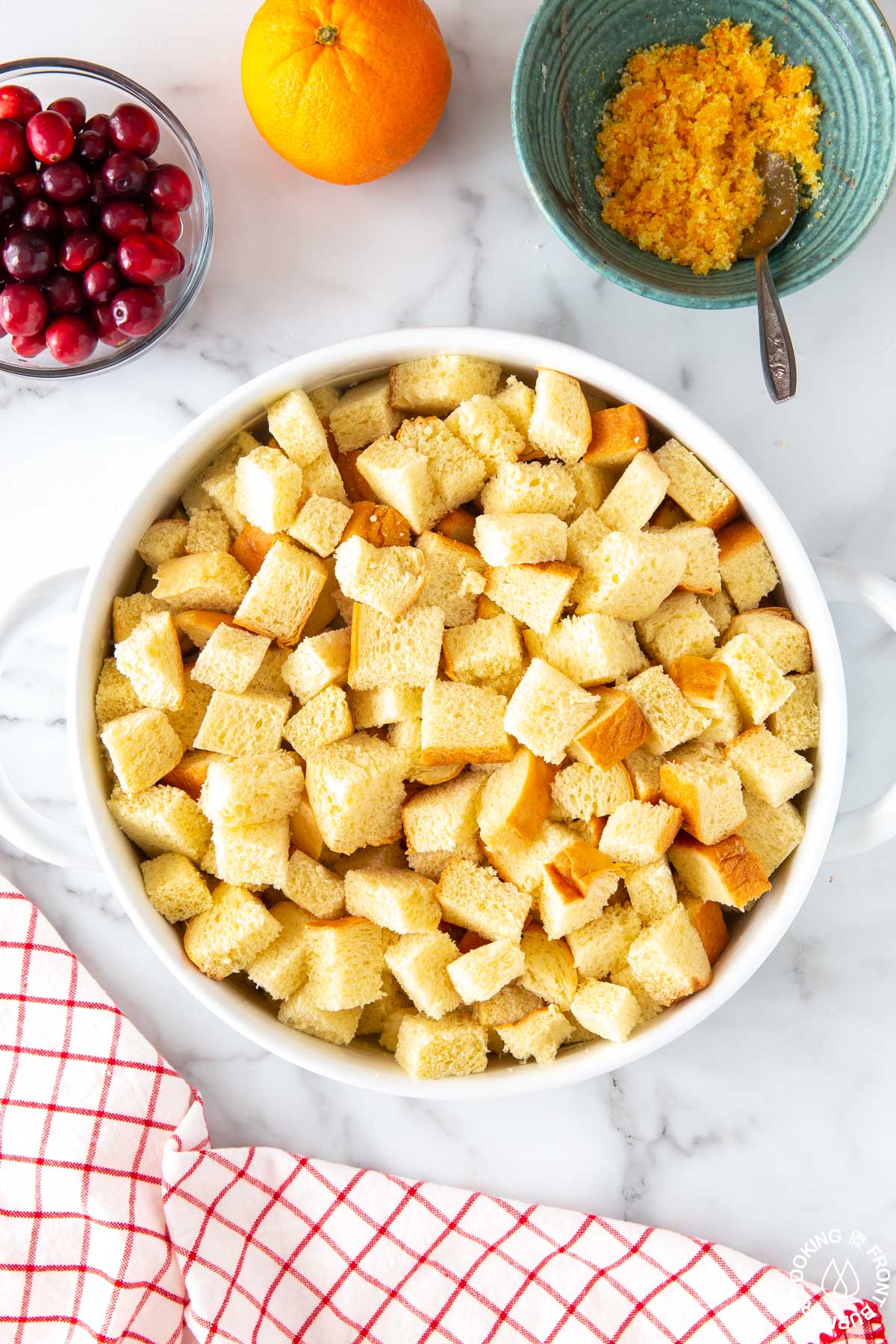 cubed brioche bread in a white baking dish