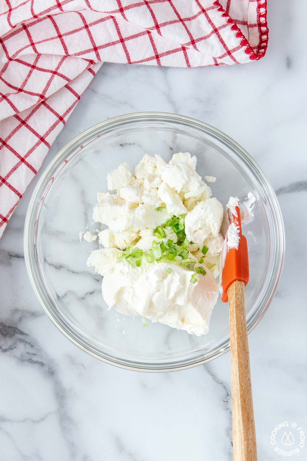 clear bowl with cream cheese, goat cheese green onion