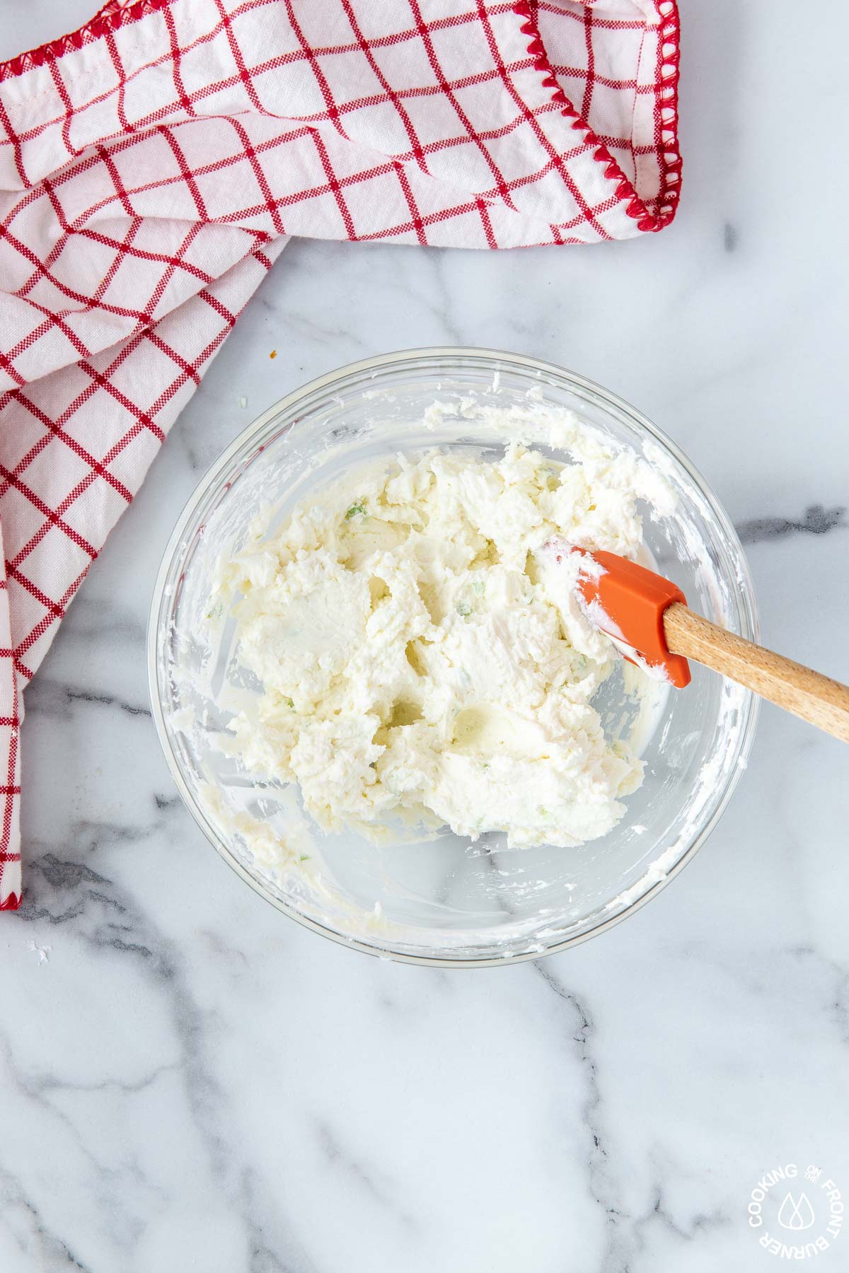 mixed cream cheese, goat cheese and green onion in bowl