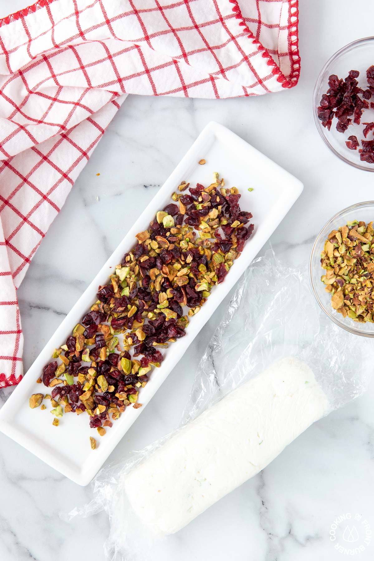 minced pistachios and cranberries on a white plate