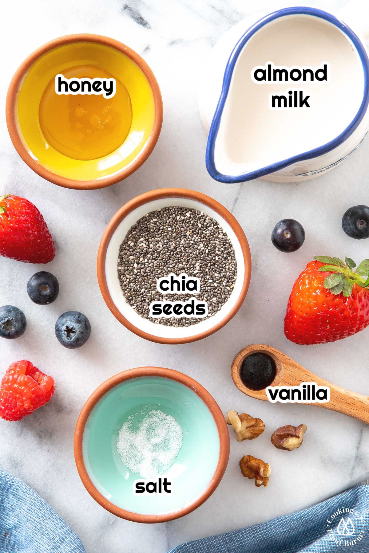 chia seeds, almond milk, honey, vanilla on a board