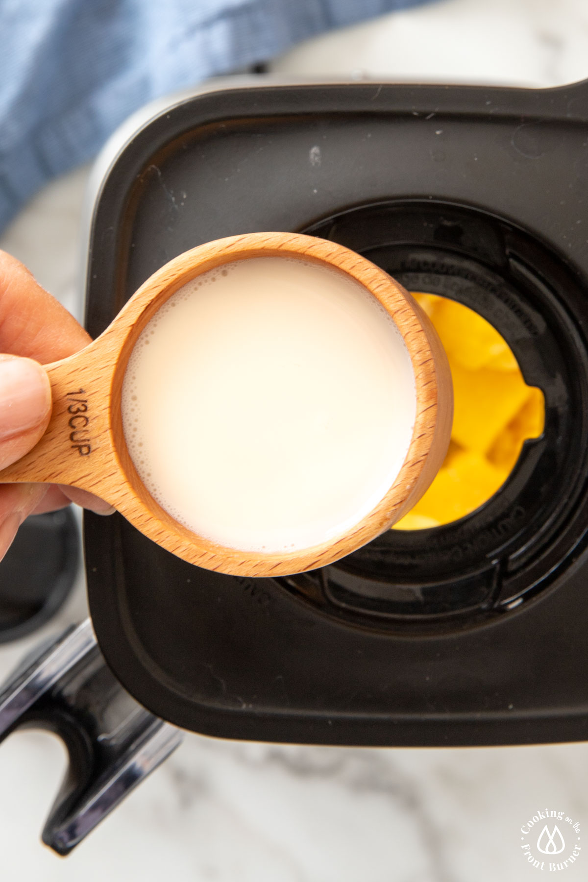 pouring almond milk in a blender