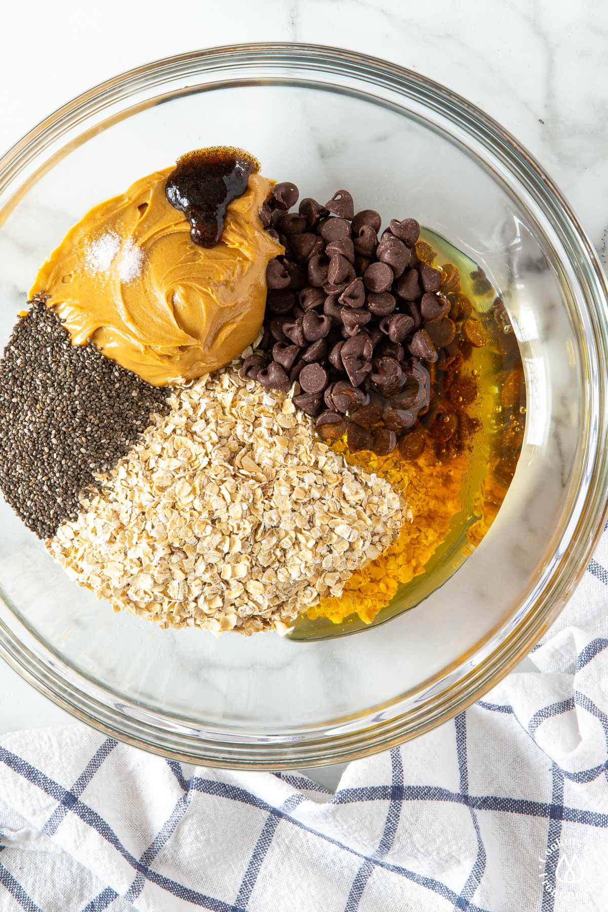 bowl with peanut butter, chocolate chips, oatmeal, salt, honey, chia seeds