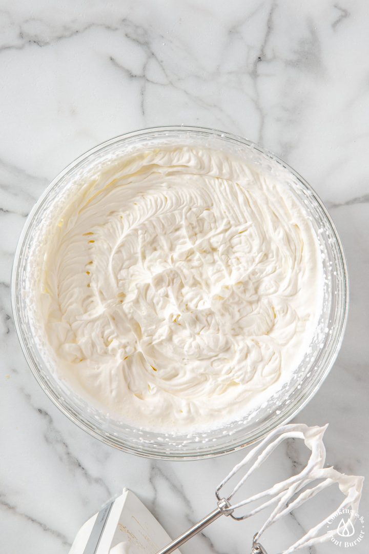 whipped cream in a clear bowl