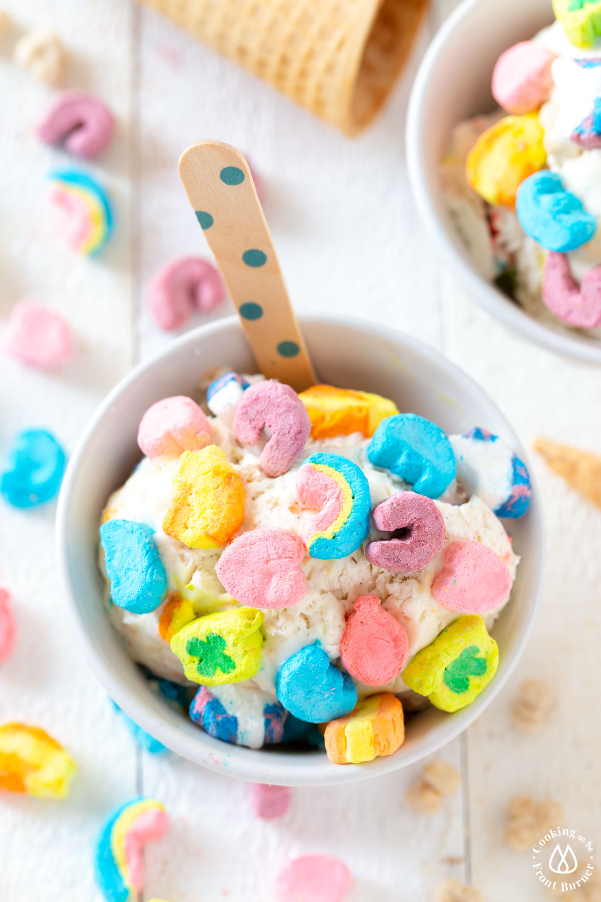 white bowl with vanilla ice cream topped with lucky charms