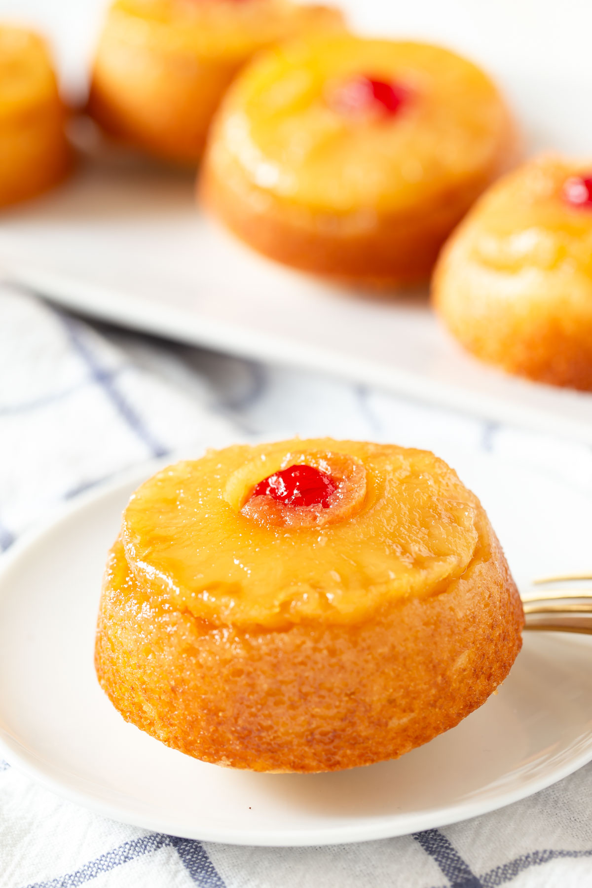 one pineapple upside down cake on a small white plate