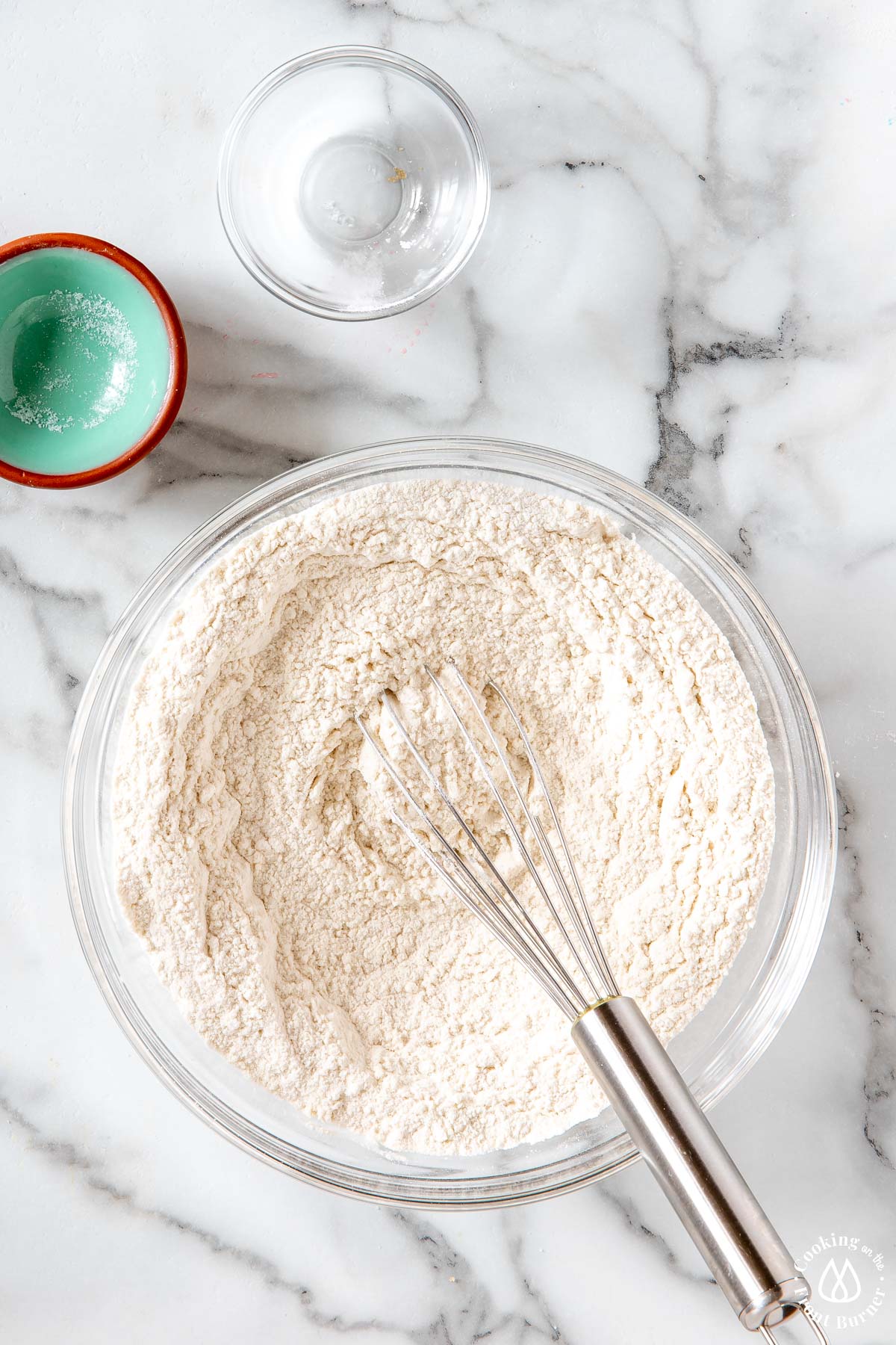 clear bowl with flour, salt and baking powder