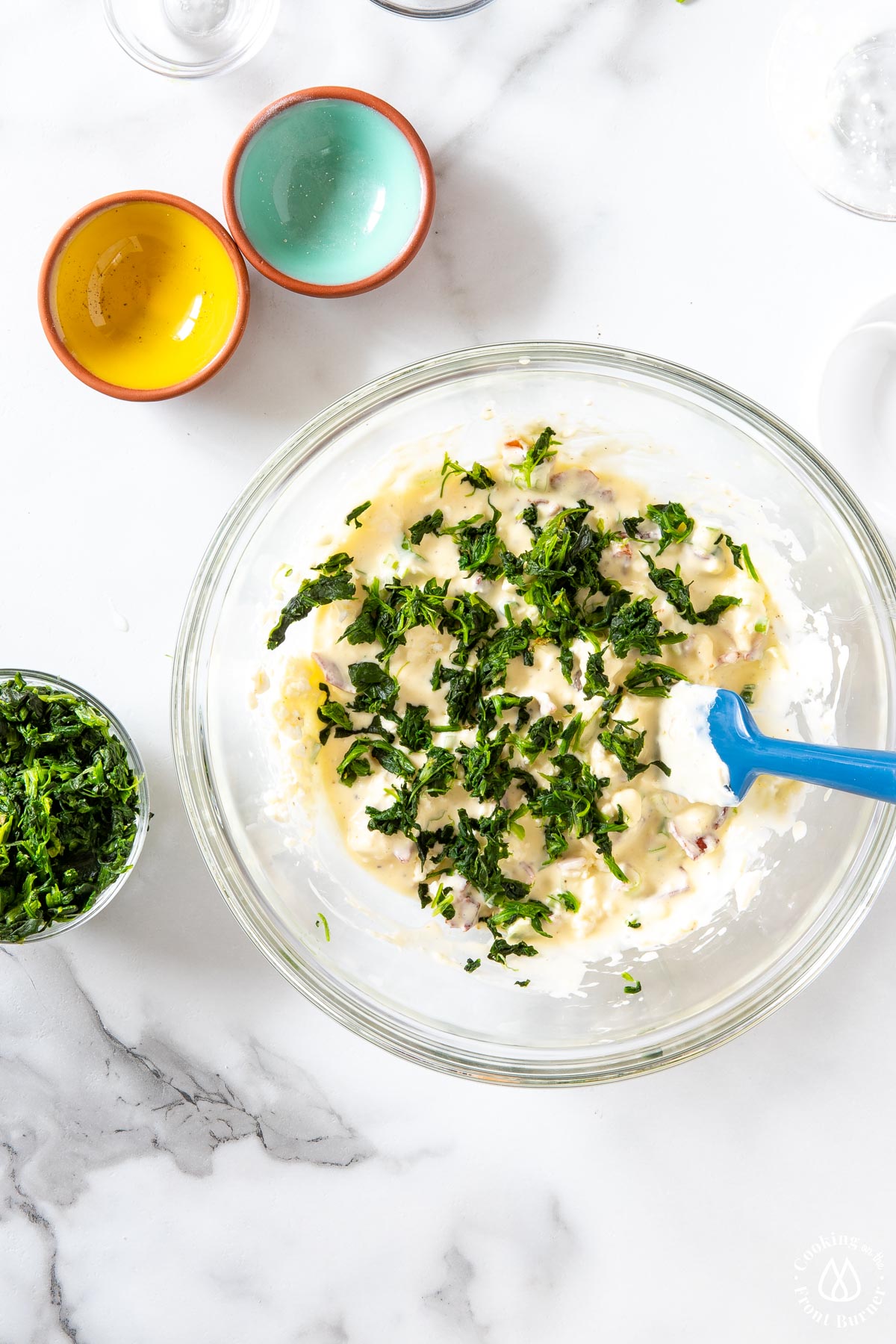 creamy feta cheese mixture and adding cooked spinach