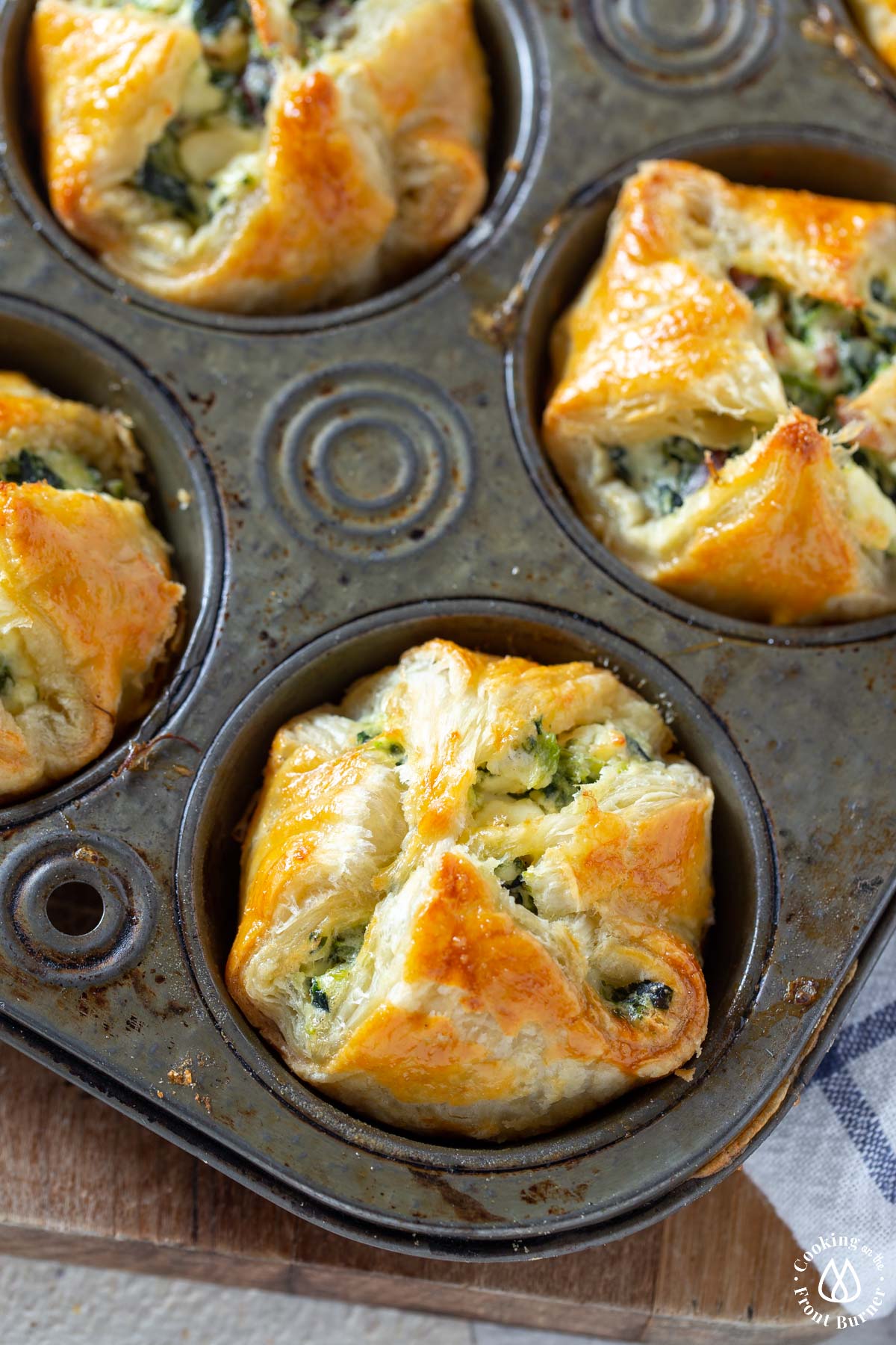 baked feta spinach puffs in a muffin tin