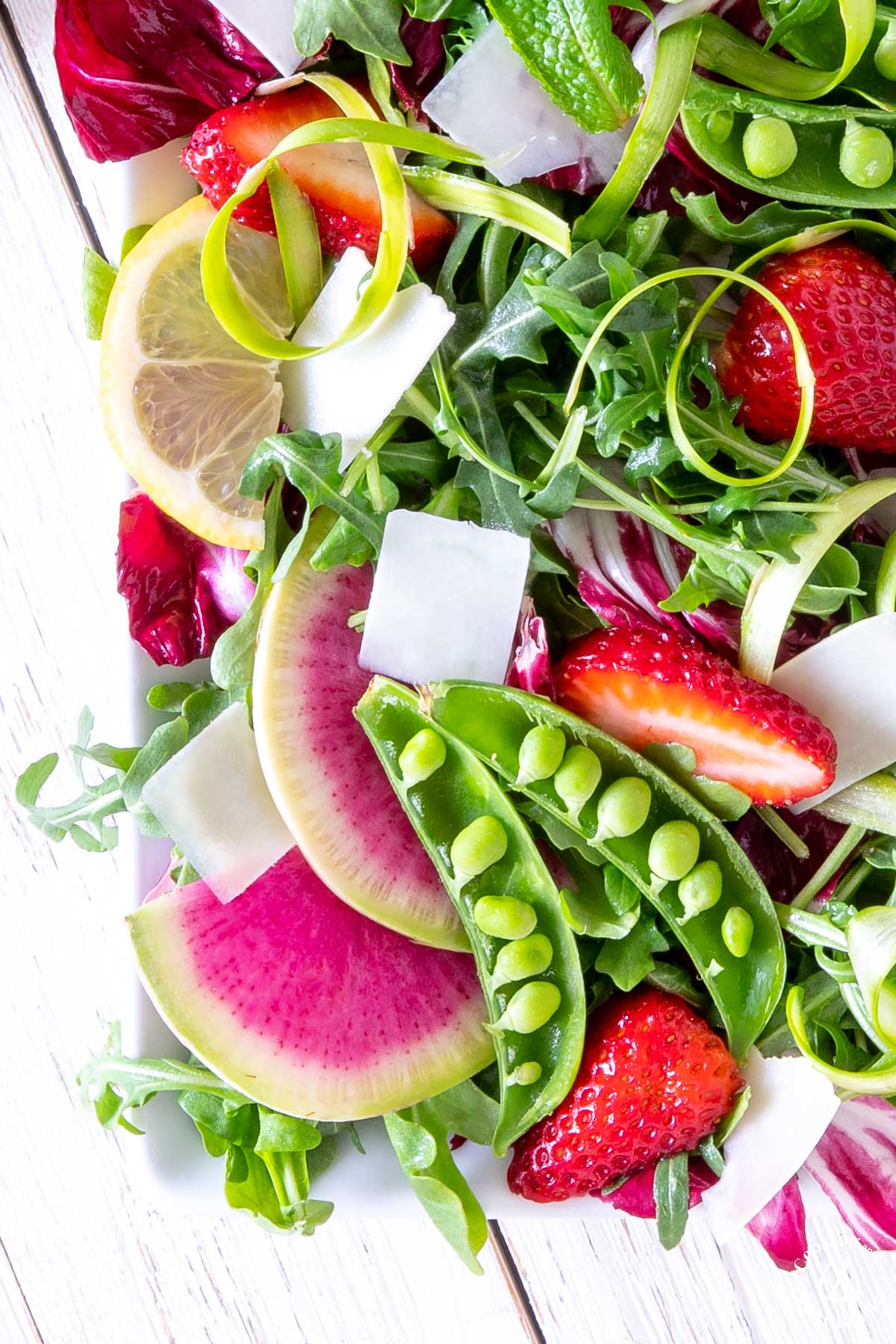 spring arugula salad on a white plate