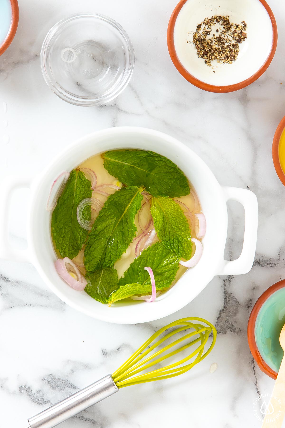 white bowl with mint leaves and shallots honey white vinegar