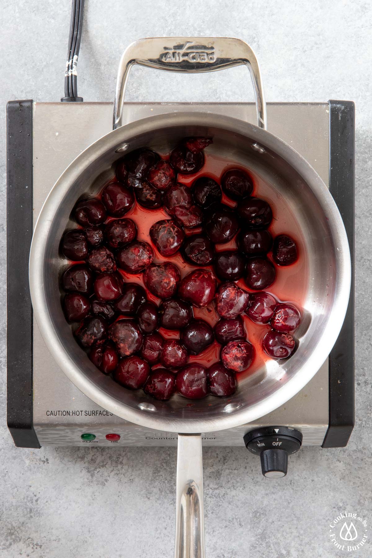 cherries in a saucepan on a burner