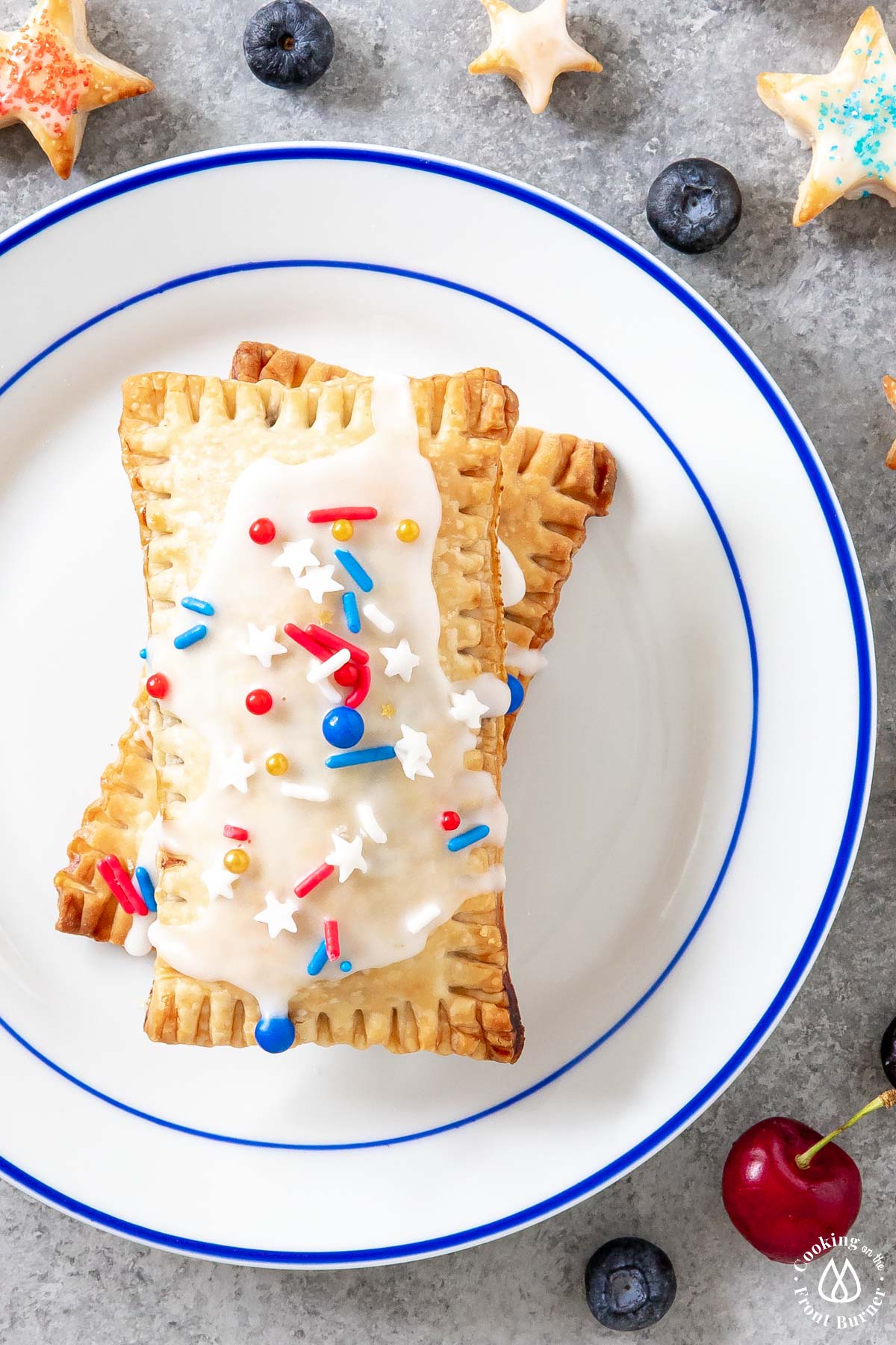 two stacked pop tarts on a white plate with blue trim