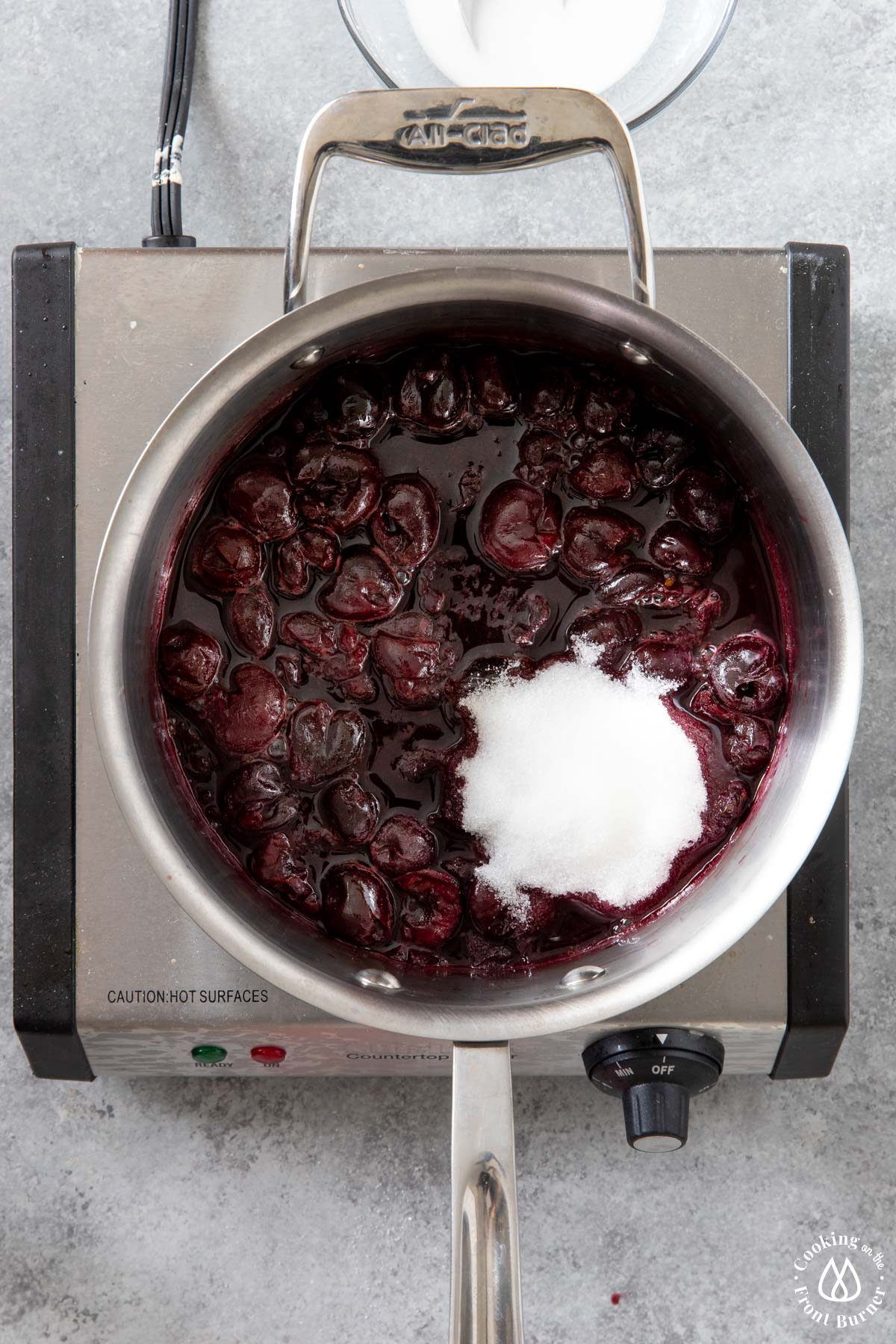 sugar added to cherry mixture in saucepan