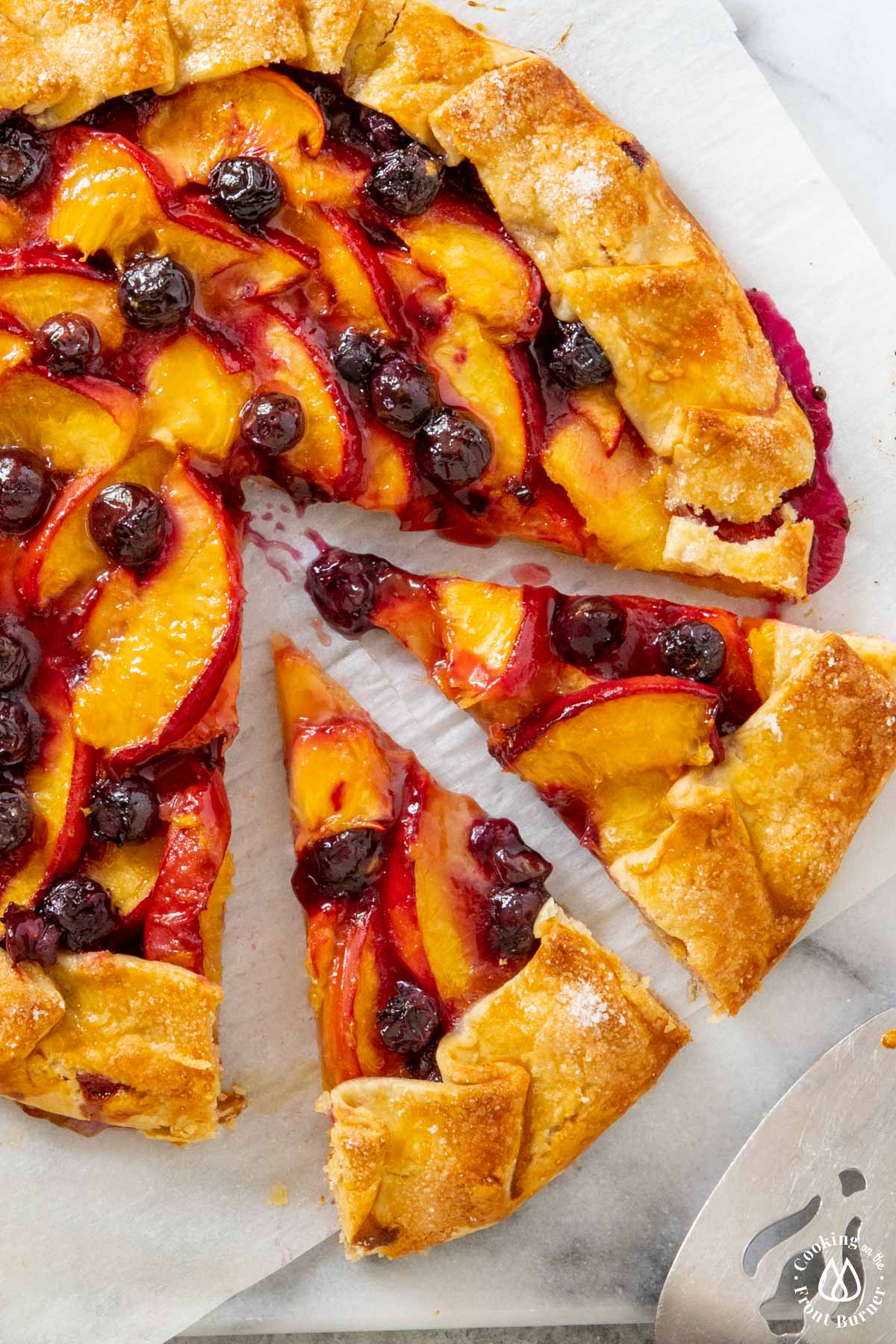 peach blueberry galette with 2 slices cut