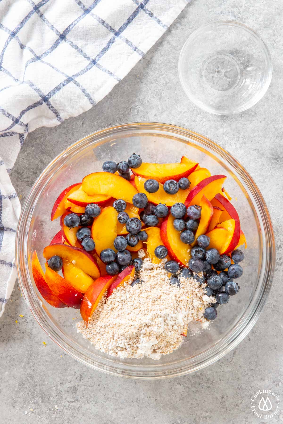 peaches and blueberries in a bowl with a brown sugar mixture